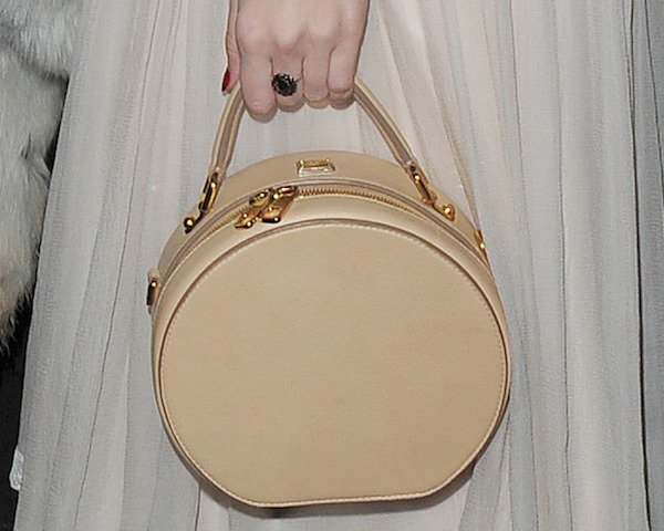 Daisy Lowe toting a circular handbag