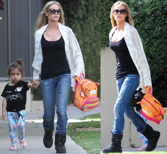 Denise Richards was spotted with her daughter Eloise Sheen in West Hollywood, California, on May 6, 2014, keeping it casual yet chic in a black tank top, distressed blue jeans, and black UGG boots, accessorized with oversized sunglasses and a lightweight white cardigan