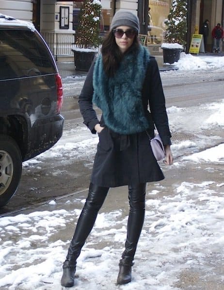 Fashion blogger Emily Lane sporting a green fur scarf with her all-black outfit