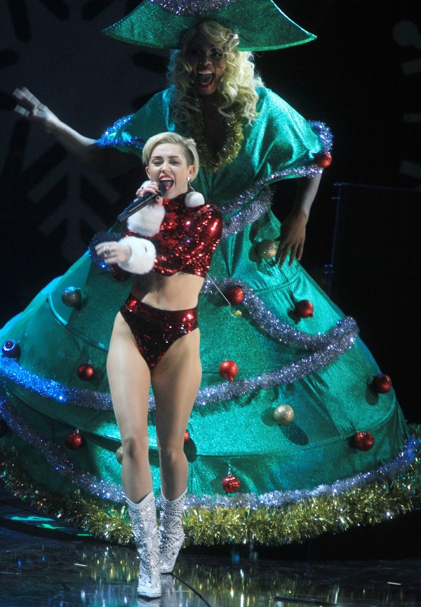 Miley Cyrus performing at Z100's Jingle Ball 2013 in a red sequined bodysuit and studded white boots