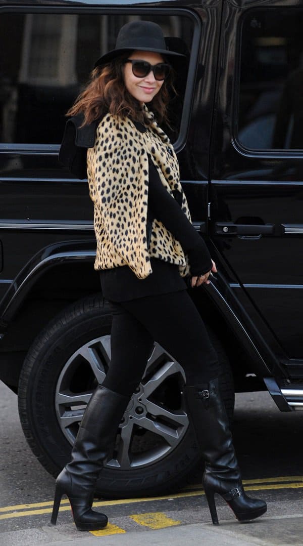 Myleene Klass styled her cheetah print cape with black leggings, sunglasses, boots, and a hat