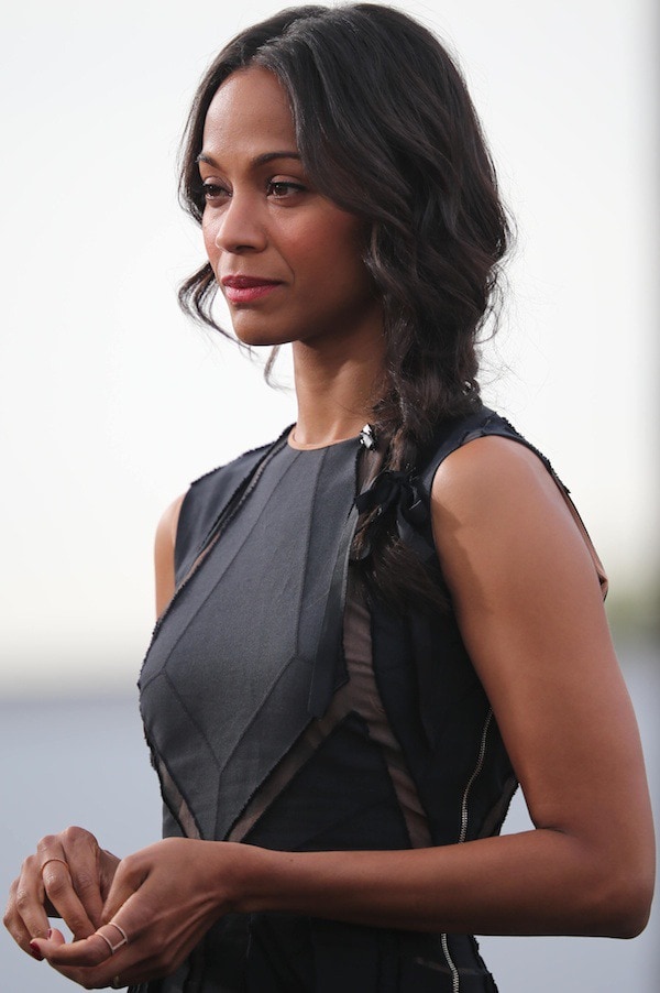 Zoe Saldaña's hair fell in soft waves and was swept to one side in a loose braid tied with a ribbon