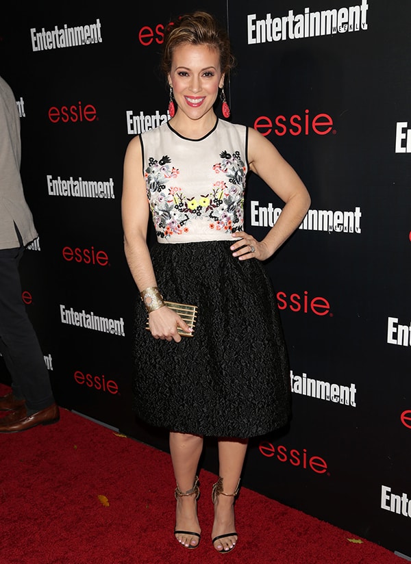 Alyssa Milano opted to look sweet and a lot younger than her age in an Erdem Resort 2014 dress that features a white bodice with floral embroidery and a textured black skirt with soft pleating