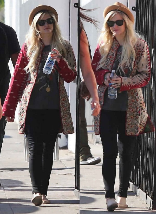 Ashlee Simpson wears a statement necklace and black skinny jeans