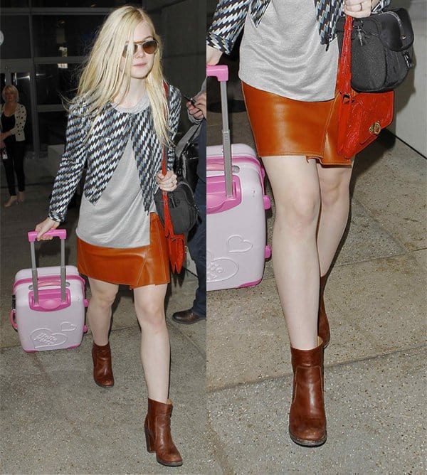 Elle Fanning's Airport Fashion Statement: Spotted at LAX, Elle Fanning redefines travel style in a snug tan leather skirt, complementing her girly persona with a pink suitcase