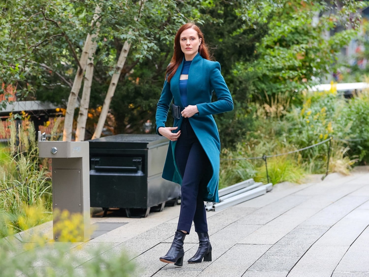 Evan Rachel Wood exudes sleek autumn elegance in pointed-toe heeled ankle boots and a teal coat while filming Westworld on New York City's High Line on October 5, 2021