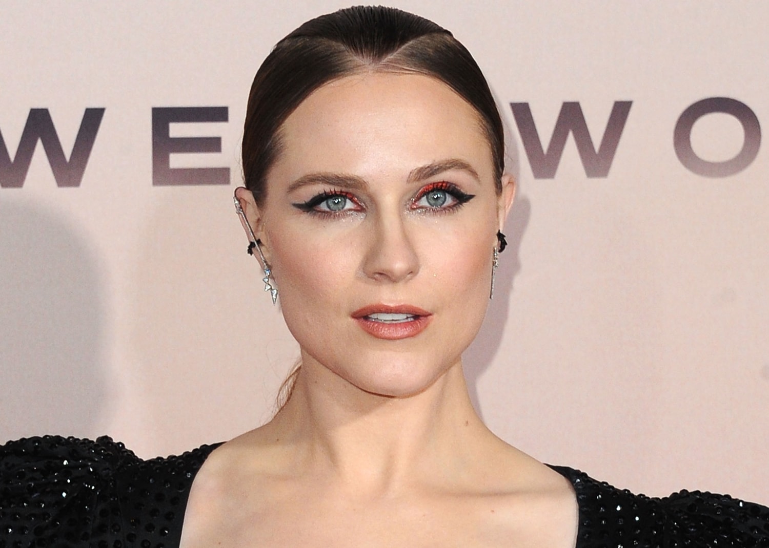 Evan Rachel Wood wears a black APM Monaco mono dragon tail sliding ear jacket and Melinda Maria earrings