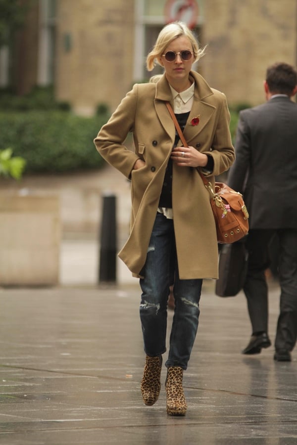 Fearne Cotton layers a camel trench coat over a collared shirt and sweater, paired with leopard print boots for a chic autumn look