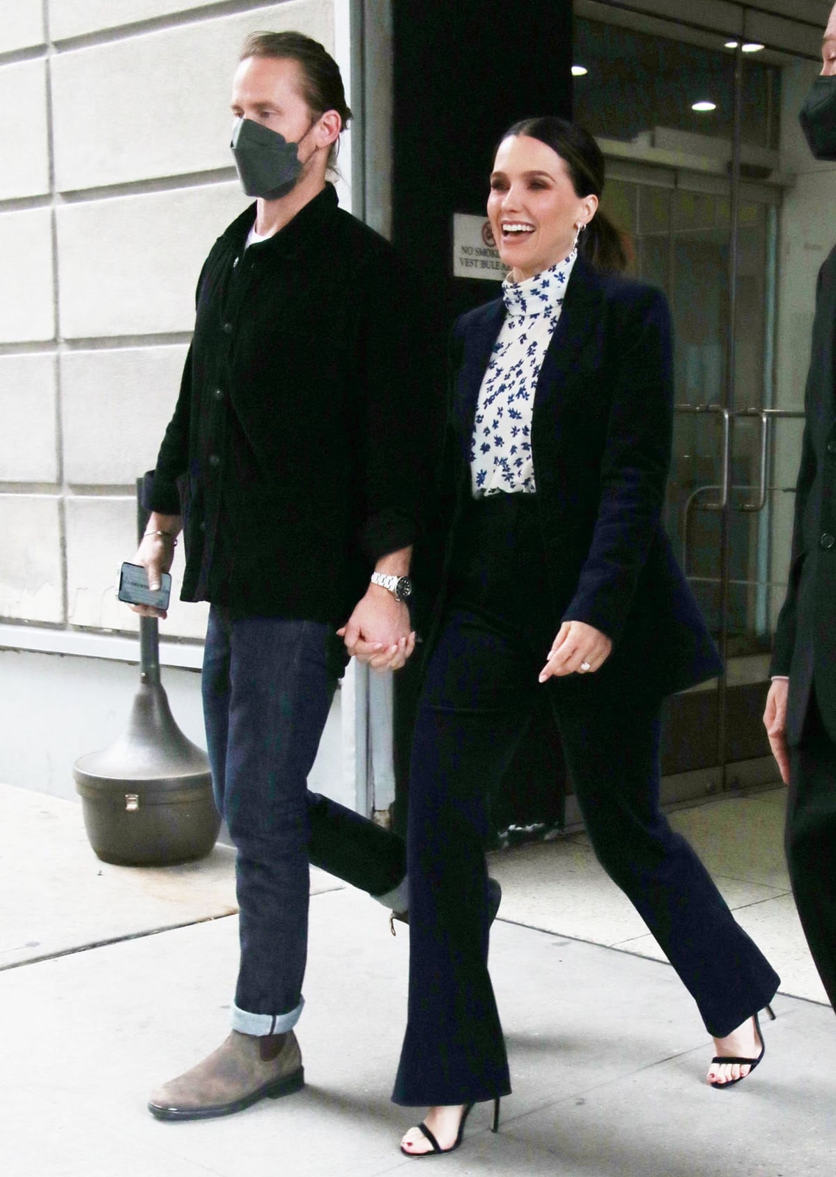 Grant Hughes and Sophia Bush, who announced their engagement in August 2021, leave their hotel