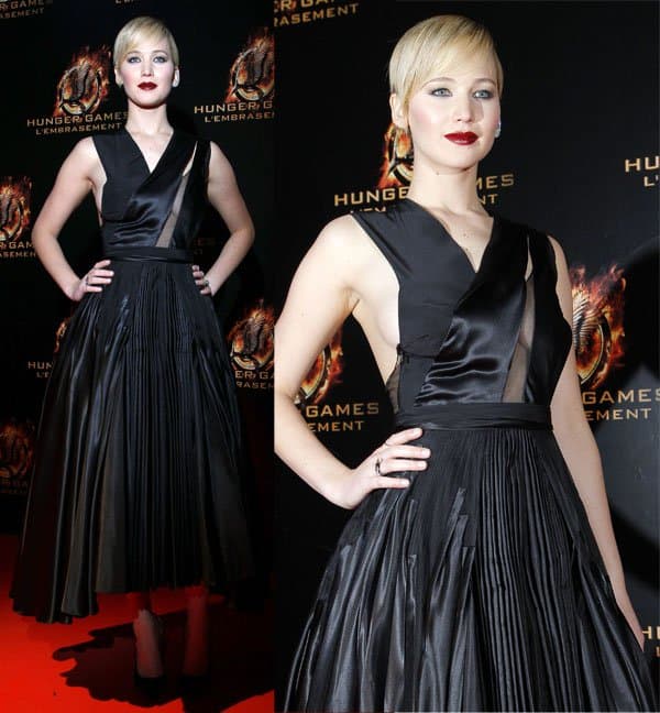 Jennifer Lawrence stuns in a striking black Dior gown with sheer panels and a bold side-boob reveal at the Paris premiere of The Hunger Games: Catching Fire