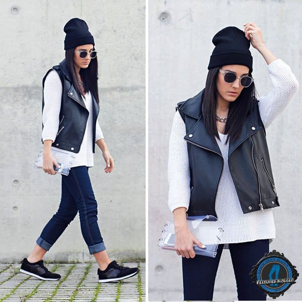Maria wears a leather vest with a beanie, jeans, and sneakers