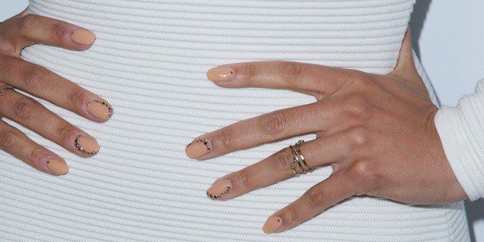 Jordin Sparks poses to show off her red, white and blue bedazzled nude manicure