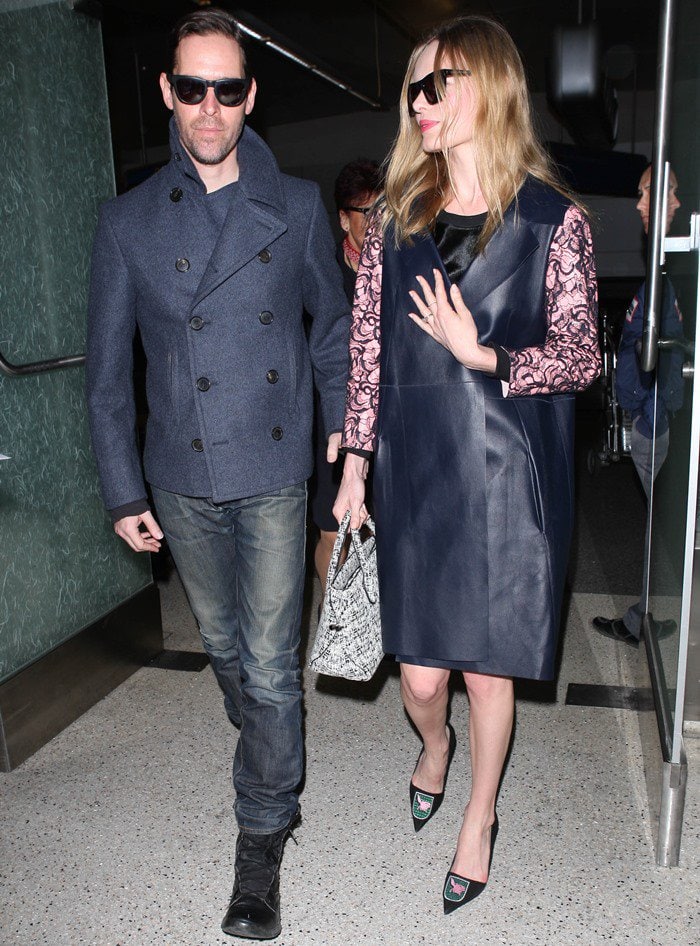 Kate Bosworth wears a lace-detailed blue leather coat as she arrives at LAX with her husband