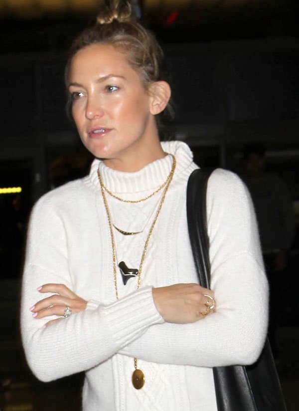 Kate Hudson effortlessly chic in a cozy white sweater and layered necklaces at LAX