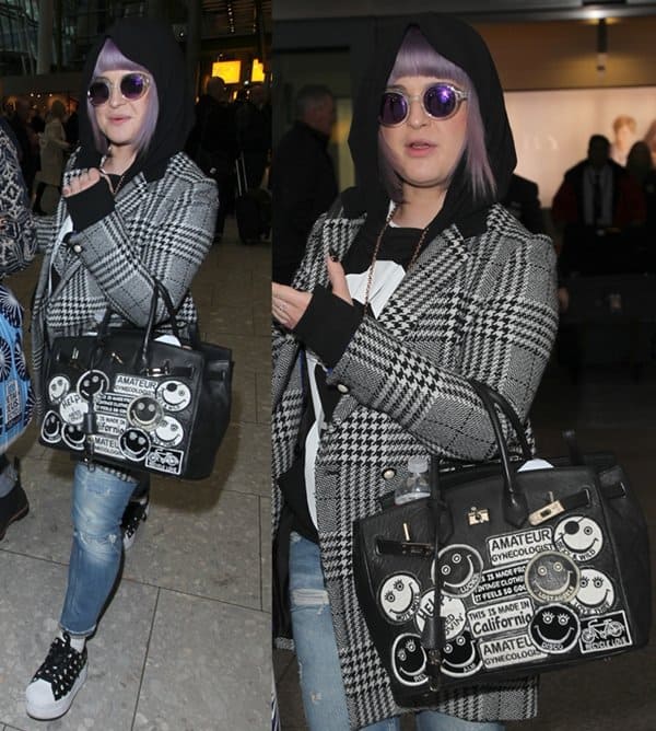 Kelly Osbourne steps out at Heathrow Airport in London on January 30, 2013, sporting a punk-inspired look with ripped jeans, studded sneakers, and a graffiti-patched black Hermès Birkin bag