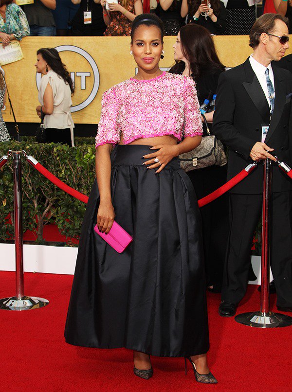 Kerry Washington touches her growing baby bump in a custom pink-and-black Prada ensemble
