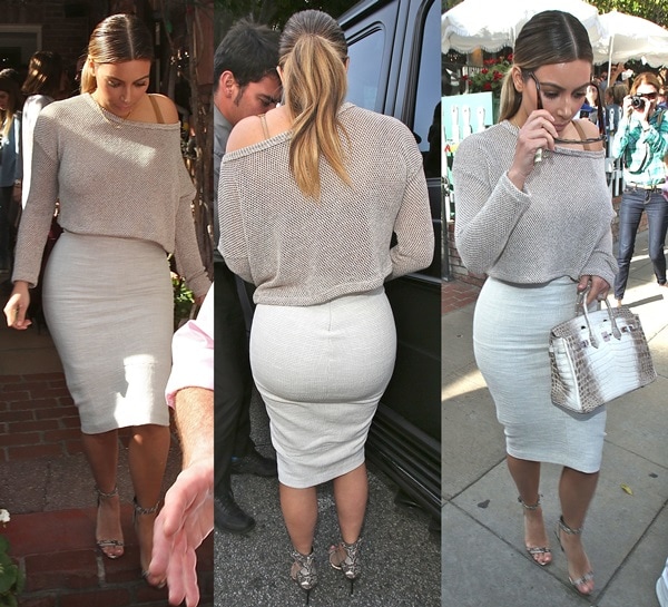 Kim Kardashian flaunts her backside in a tight white pencil skirt paired with a long-sleeved knit top