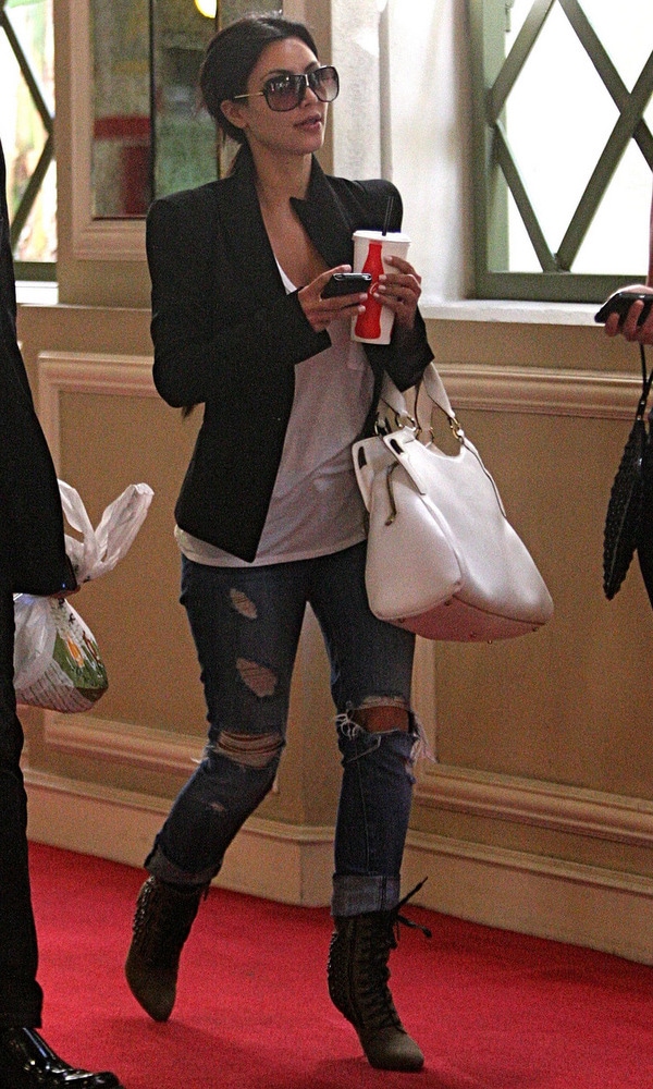 Kim Kardashian in glamorous ripped jeans on her way to an event at The Grove, Los Angeles, April 7, 2010