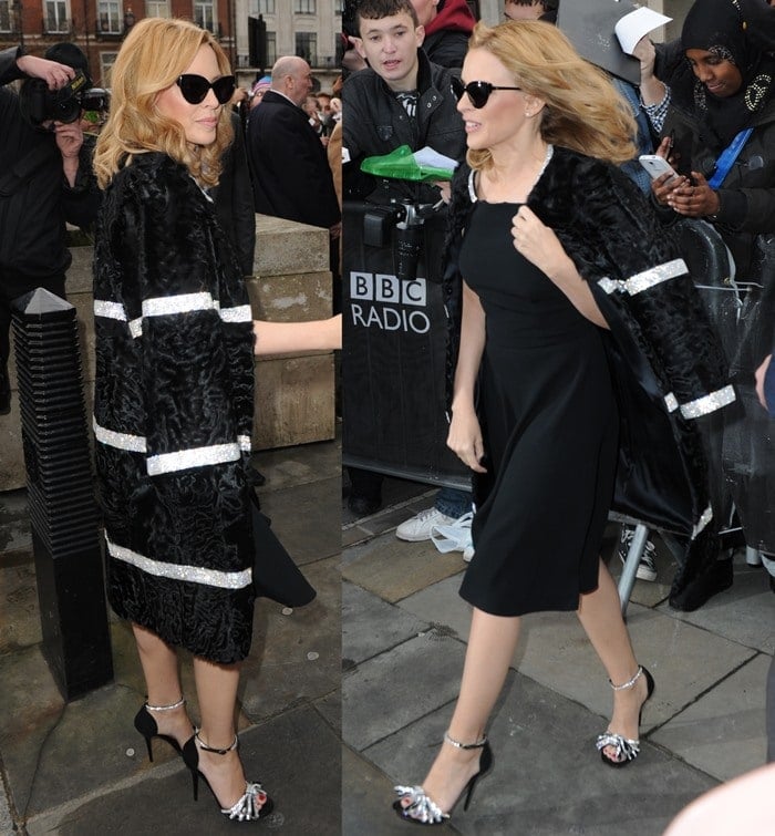 Kylie Minogue wears her hair down as she poses with fans outside BBC Radio One