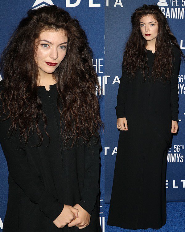 Lorde wears a long black Acne dress on the blue carpet