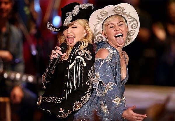 Madonna and Miley Cyrus sticking their tongues out in the finale of Miley Cyrus' MTV Unplugged concert, filmed at Sunset Gower Studios in Los Angeles, California, and aired on January 29, 2014