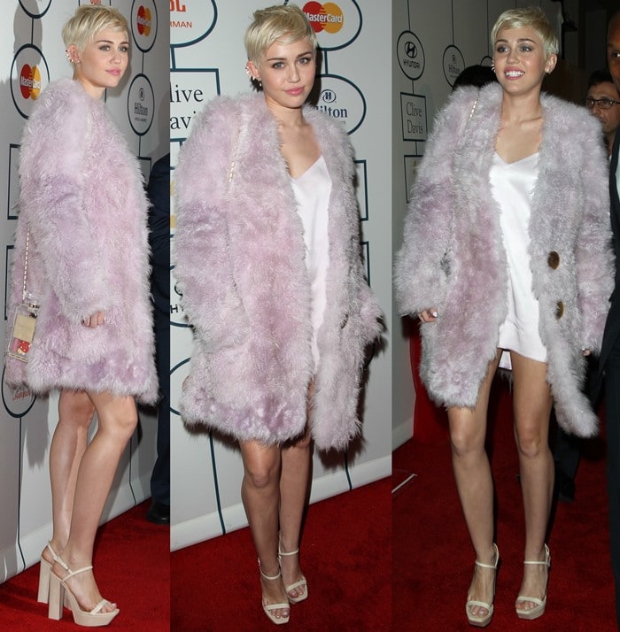 Miley Cyrus in a slinky white Calvin Klein dress paired with an ice pink shearling coat, a Chanel “No. 5 Perfume Bottle” bag, a diamond 4-row berbère earring by Repossi, and cream colored ankle-strap block heels by Calvin Klein