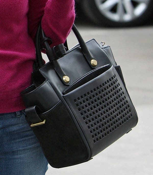 Reese Witherspoon adds a touch of sophistication to her casual look with the luxurious and functional Reed Krakoff Atlantique Bionic mini leather tote