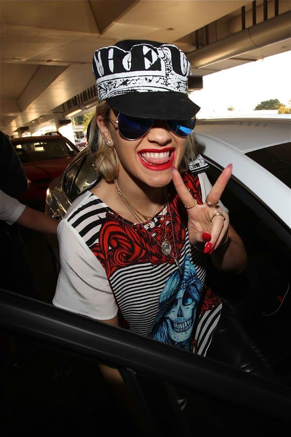 Rita Ora being friendly and in good spirits after a long flight