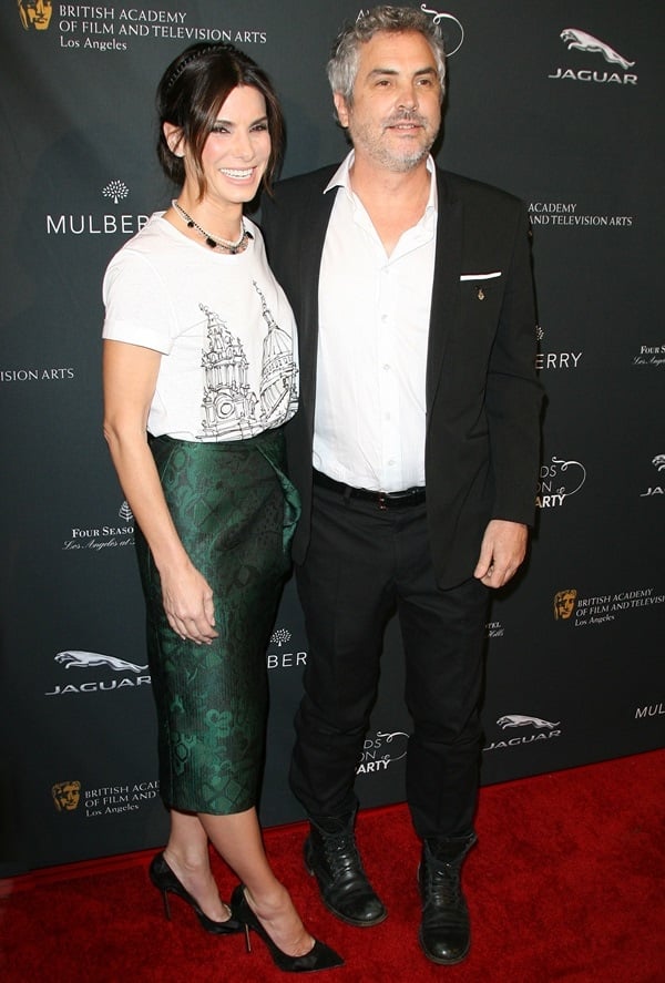 Director Alfonso Cuaron and Sandra Bullock pose for photos at the 2014 BAFTA Awards Season Tea Party