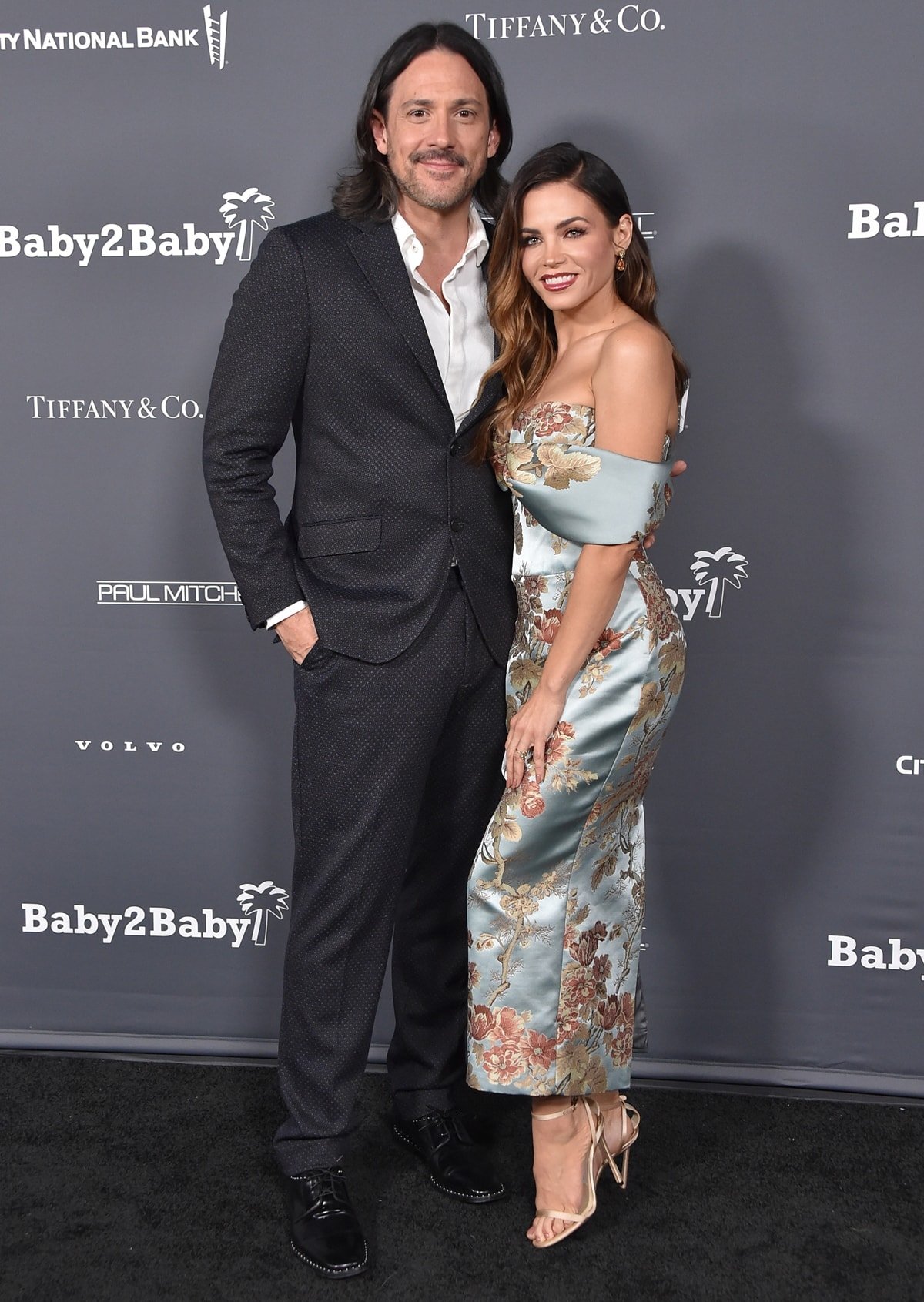 Jenna Dewan in an off-the-shoulder Rasario floral print corset dress, Candy Ice earrings, a Le Vian ring, and Jimmy Choo sandals with her boyfriend Steve Kazee at the 2021 Baby2Baby Gala Presented by Paul Mitchell