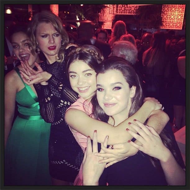 Odeya Rush, Sarah Hyland, and Hailee Steinfeld pose for a photo—while Taylor Swift steals the spotlight with a playful photobomb at the Golden Globes after-party