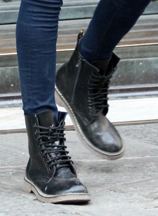 Cara Delevingne wears a pair of bulky boots while filming in Italy