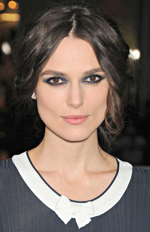 Keira Knightley with her hair pulled back into a messy updo