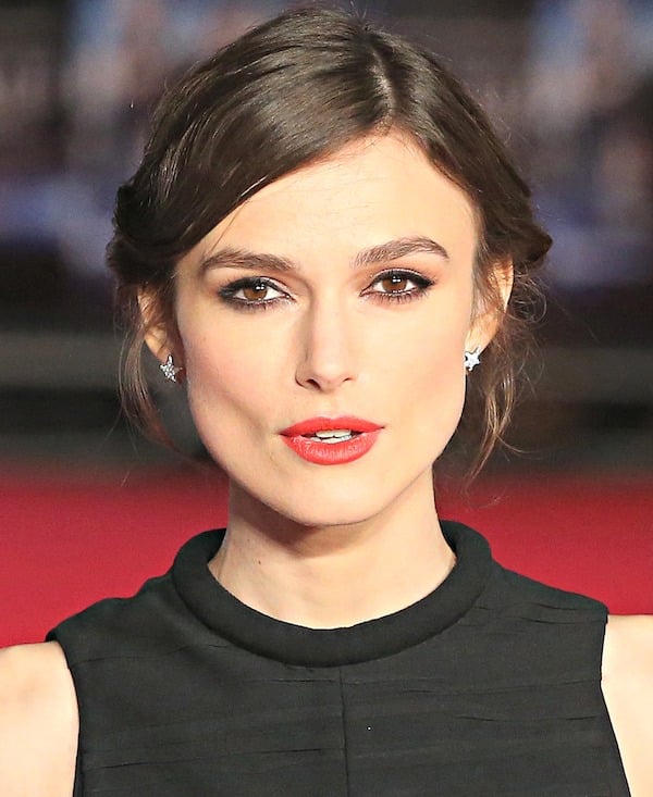 Keira Knightley's hair was styled in a wispy updo, which showcased her star-shaped earrings, kohl-rimmed eyes, and perfect red pout