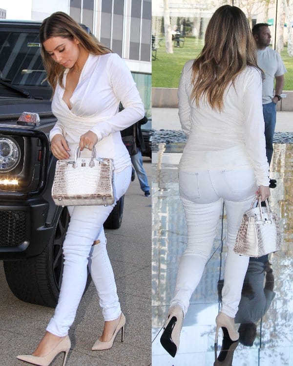 Kim Kardashian was spotted in Los Angeles on January 10, 2014, wearing a Donna Karan New York stretch jersey wrap effect top, J Brand 811 mid rise skinny jeans in blanc, Saint Laurent Paris pointed suede pumps, and carrying a Hermes Himalayan Birkin bag