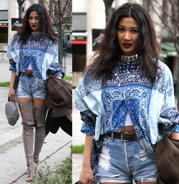 Ambush designer Yoon Ahn rocking a printed shirt with high-waist denim shorts and open-toe, thigh-high lace-up boots for the Louis Vuitton Fall 2014 Menswear show during Paris Fashion Week