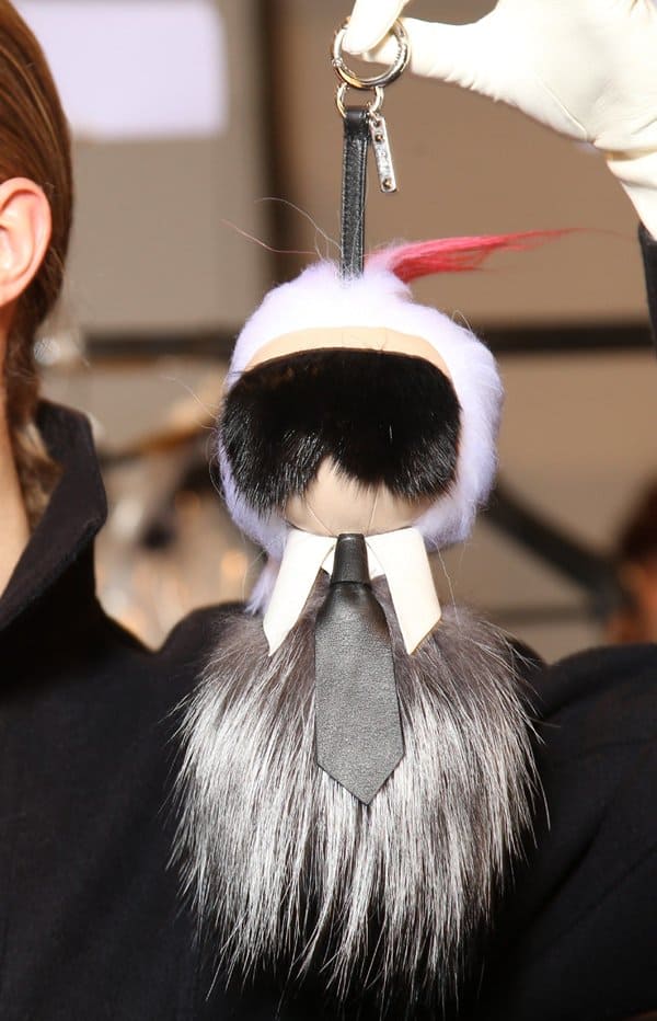 Cara Delevingne showcases Fendi’s miniature Karlito bag bug, a playful and luxurious tribute to Karl Lagerfeld