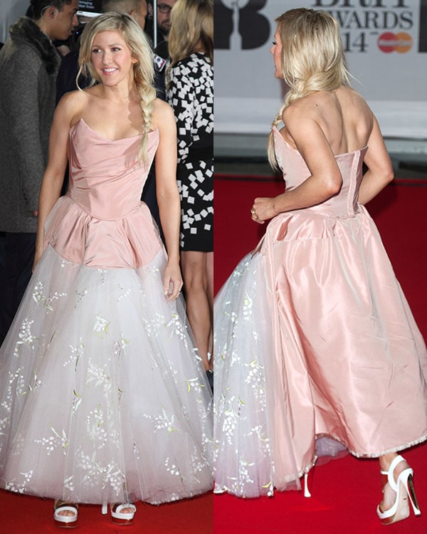 Ellie Goulding wears a Vivienne Westwood dress and a pair of Sergio Rossi heels on the red carpet of the BRIT Awards