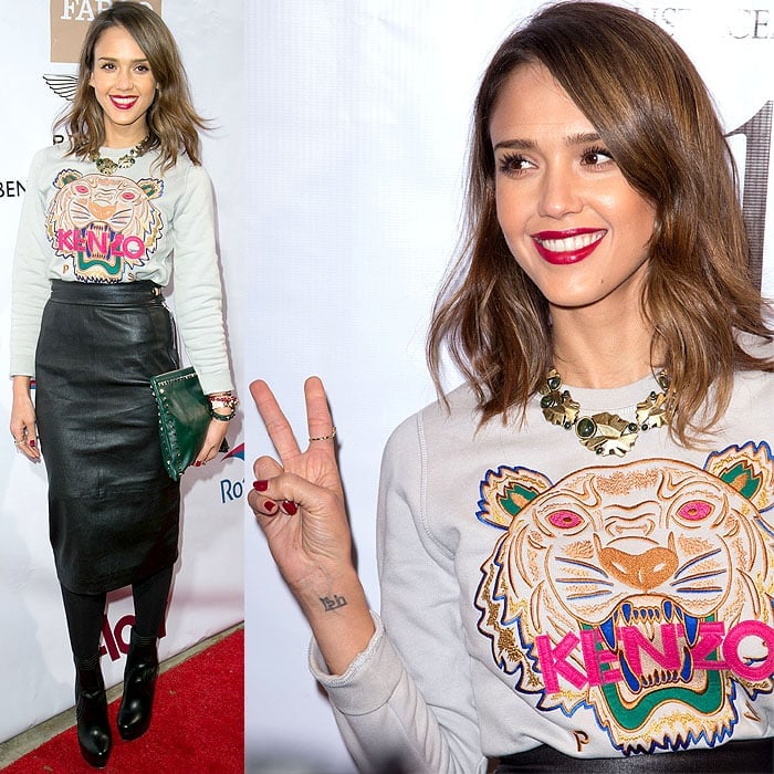 Jessica Alba opted for the street-style-favorite Kenzo tiger sweatshirt and paired it with an almost mumsy high-waisted, knee-length leather skirt