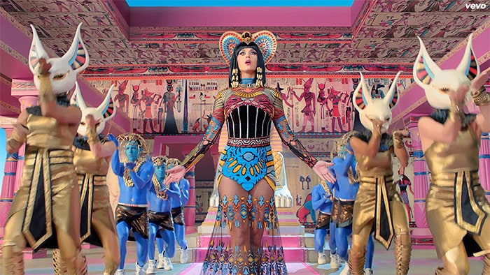 Katy Perry commands the stage in a vibrant Nicolas Jebran gown, surrounded by dancers in metallic gladiator sandals and bold Egyptian-inspired costumes