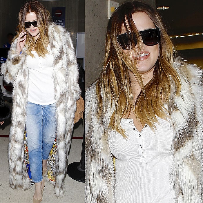 Khloe Kardashian wears her hair down in a faux-fur coat with "FXCK Yo Fur" spray painted on the back