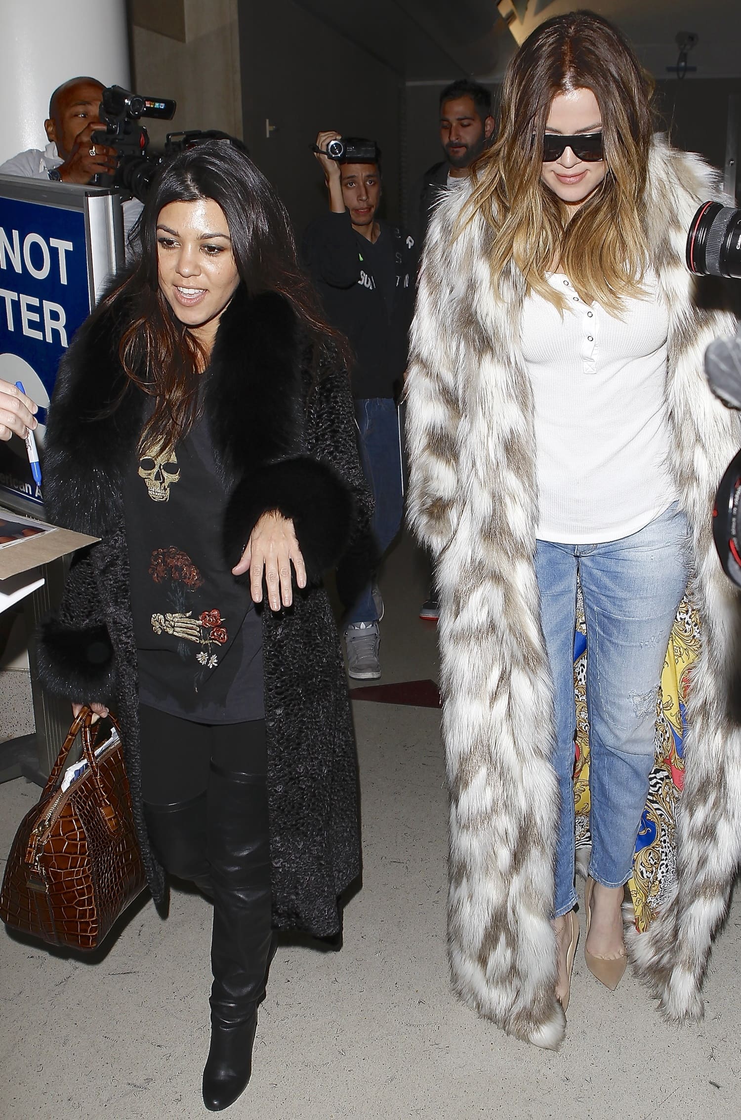 Khloe and Kourtney Kardashian arrive at Los Angeles International (LAX) airport