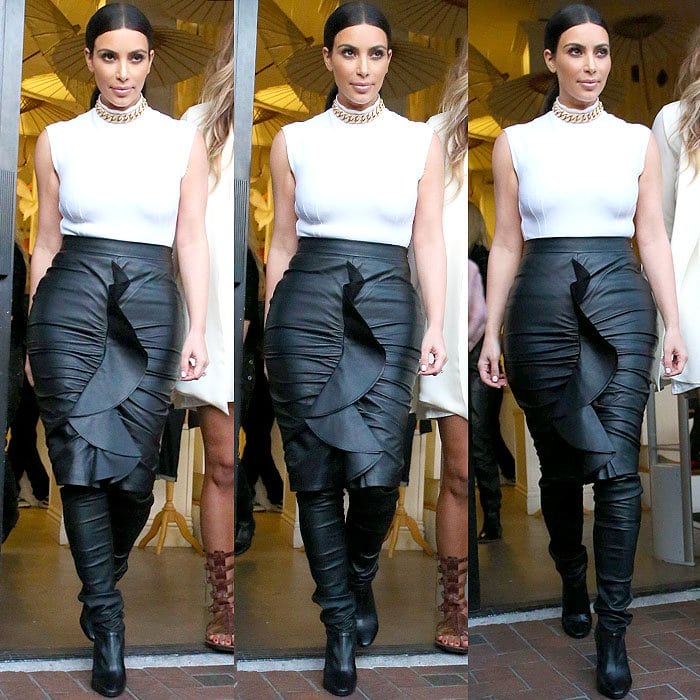 Kim Kardashian wearing Tamara Mellon's edgy "Sweet Revenge" leather legging boots paired with a sculptural Givenchy ruffled pencil skirt and a sleek Lanvin scuba turtleneck top