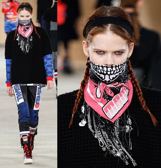 A model walks the Marc by Marc Jacobs Fall 2014 runway at New York Fashion Week, featuring an edgy ensemble with a pink skull-print bandana, layered necklaces, and bold patterned leggings