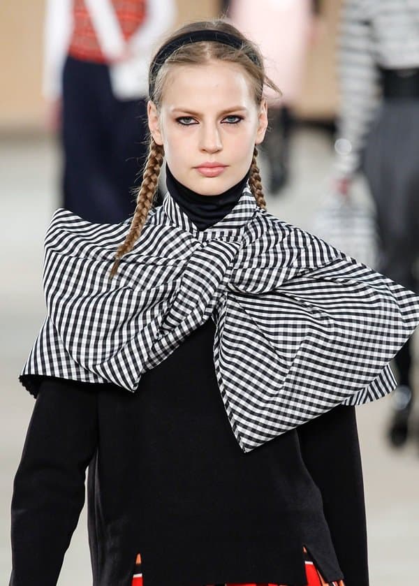 A model on the Marc by Marc Jacobs Fall 2014 runway at New York Fashion Week, sporting a striking black and white checkered oversized bow collar