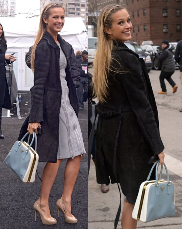 Petra Němcová turned heads outside the Hervé Léger by Max Azria Fashion Show on February 9, 2014, in Manhattan, effortlessly pairing nude platform pumps with a pastel blue Prada Pyramid tote and a tailored black coat over a bandage-style dress