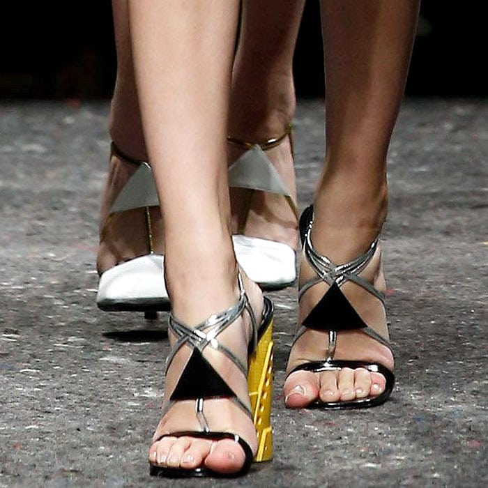 Prada's bold wedge sandals featuring metallic straps and vibrant yellow geometric heels