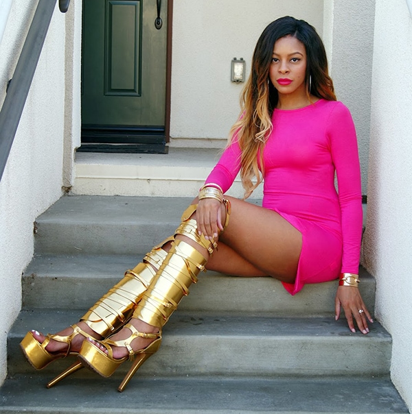 Slim wears a sexy pink dress with metallic gold boots