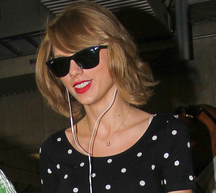 Taylor Swift wears her hair down to show off her Ray-Ban sunglasses while out shopping