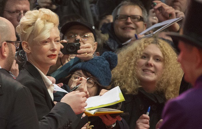 Tilda Swinton signs autographs for fans at the premiere of "The Grand Budapest Hotel"